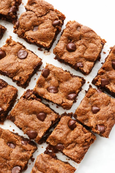 almond butter blondies sliced on white surface.