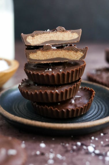 almond butter cups stacked on plate.