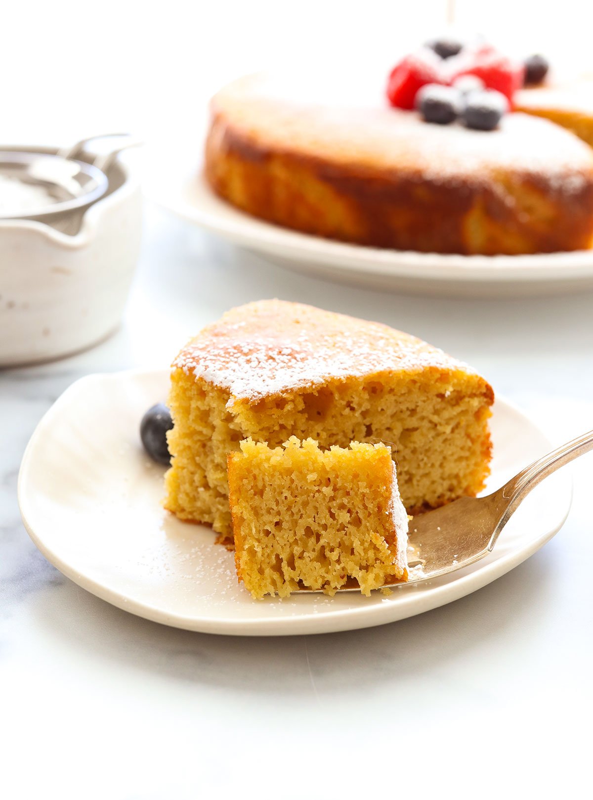 almond flour cake slice with bite removed on a fork.