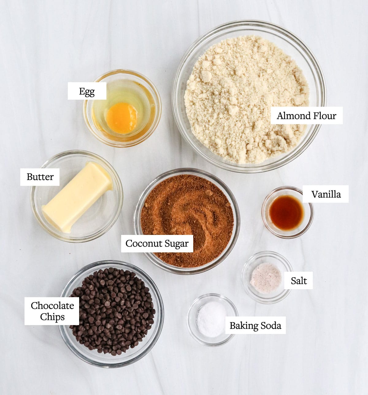 almond flour cookie ingredients labeled in glass bowls.