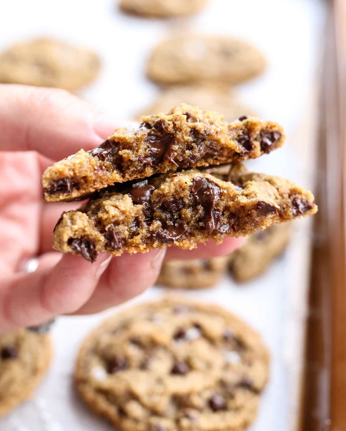 hand holding an almond flour cookie split in half.