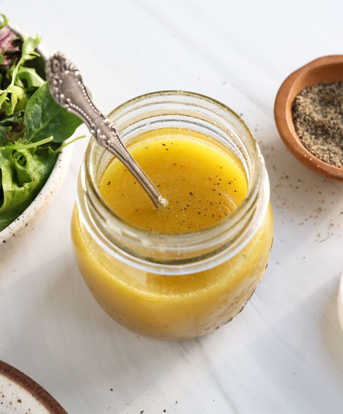 apple cider dressing with spoon in jar