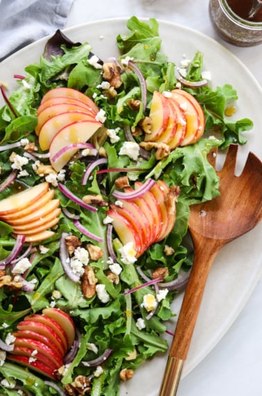 apple walnut salad served with wooden spork.