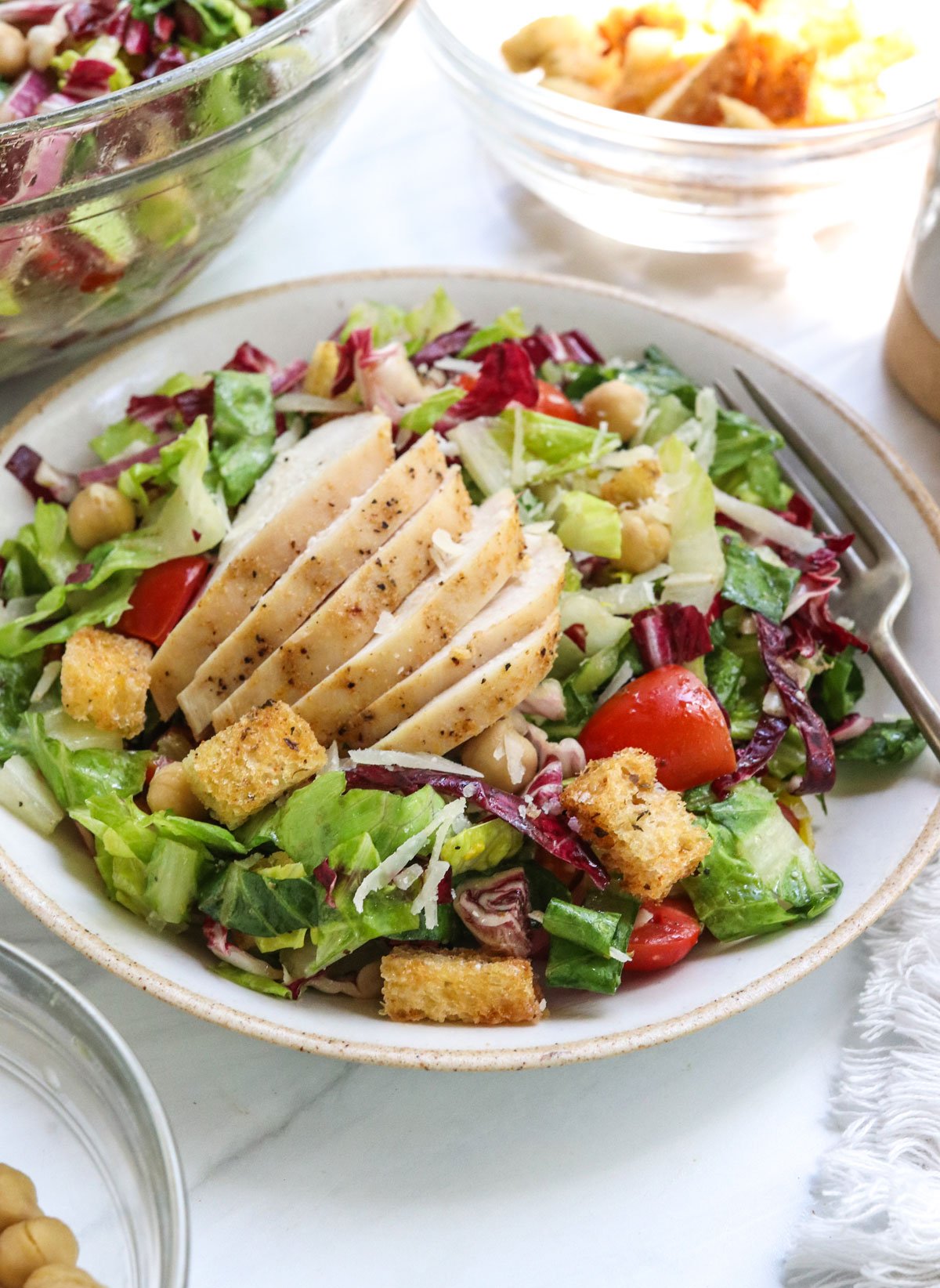 chicken breast served on italian salad.