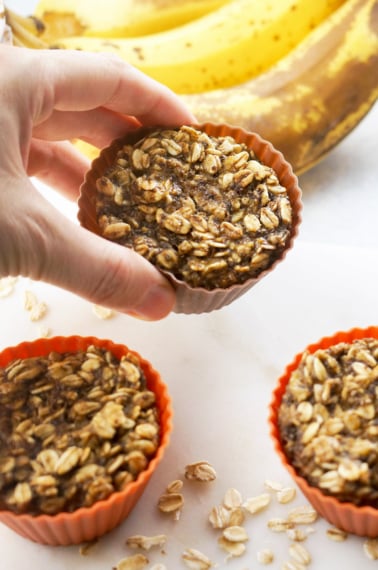 hand holding Vegan Baked Banana Oatmeal Cup