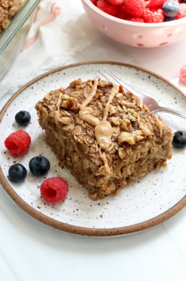 banana baked oatmeal served with berries.