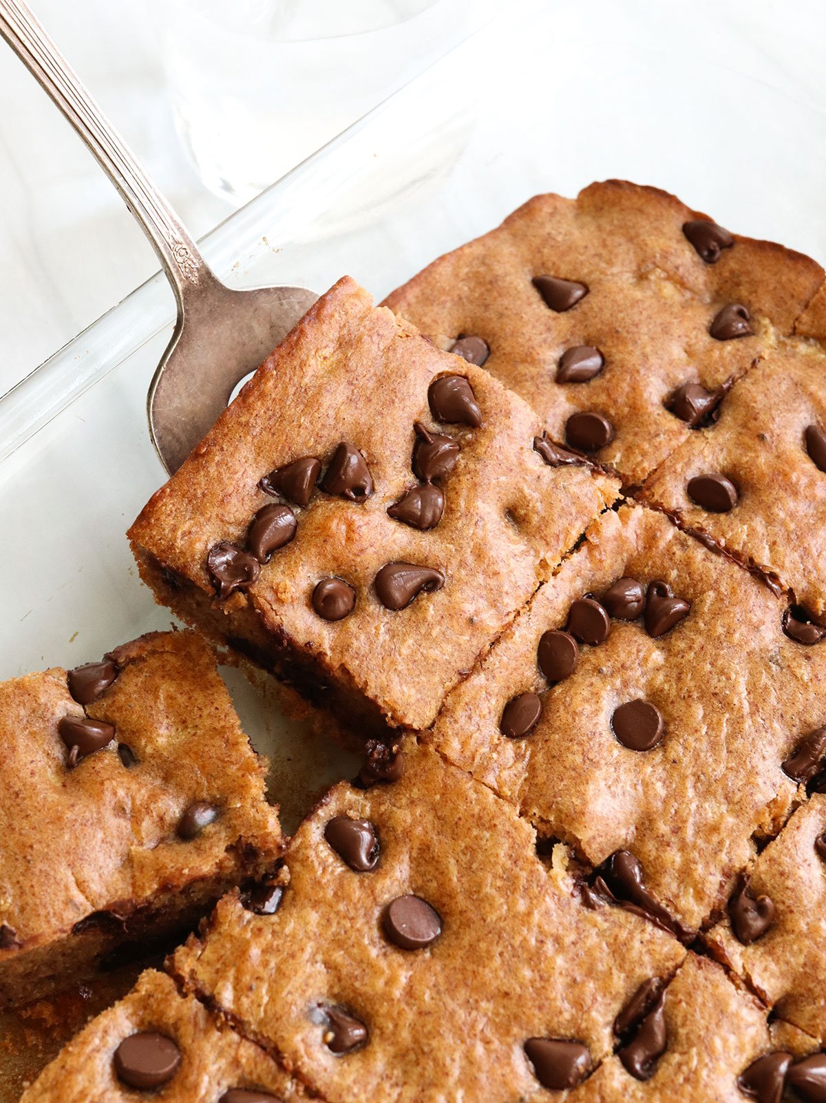 banana snack cake slice lifted on spatula.