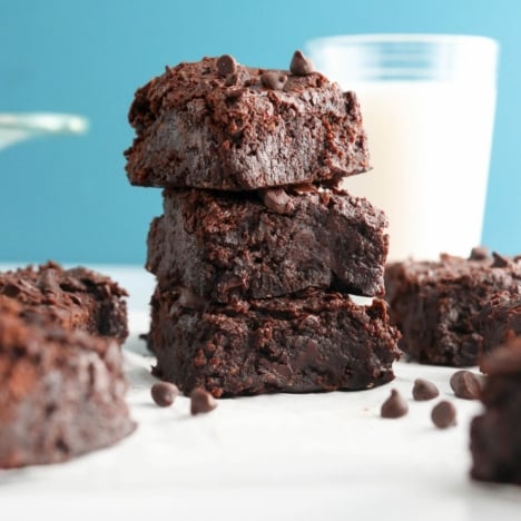 black bean brownies stacked with blue background