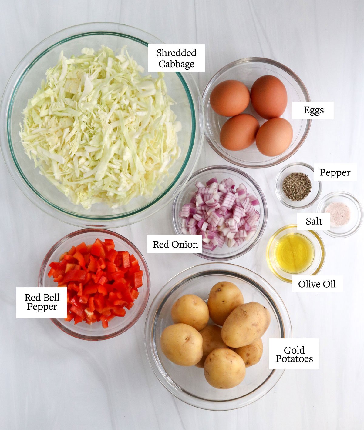 breakfast bowl ingredients in glass bowls on white surface