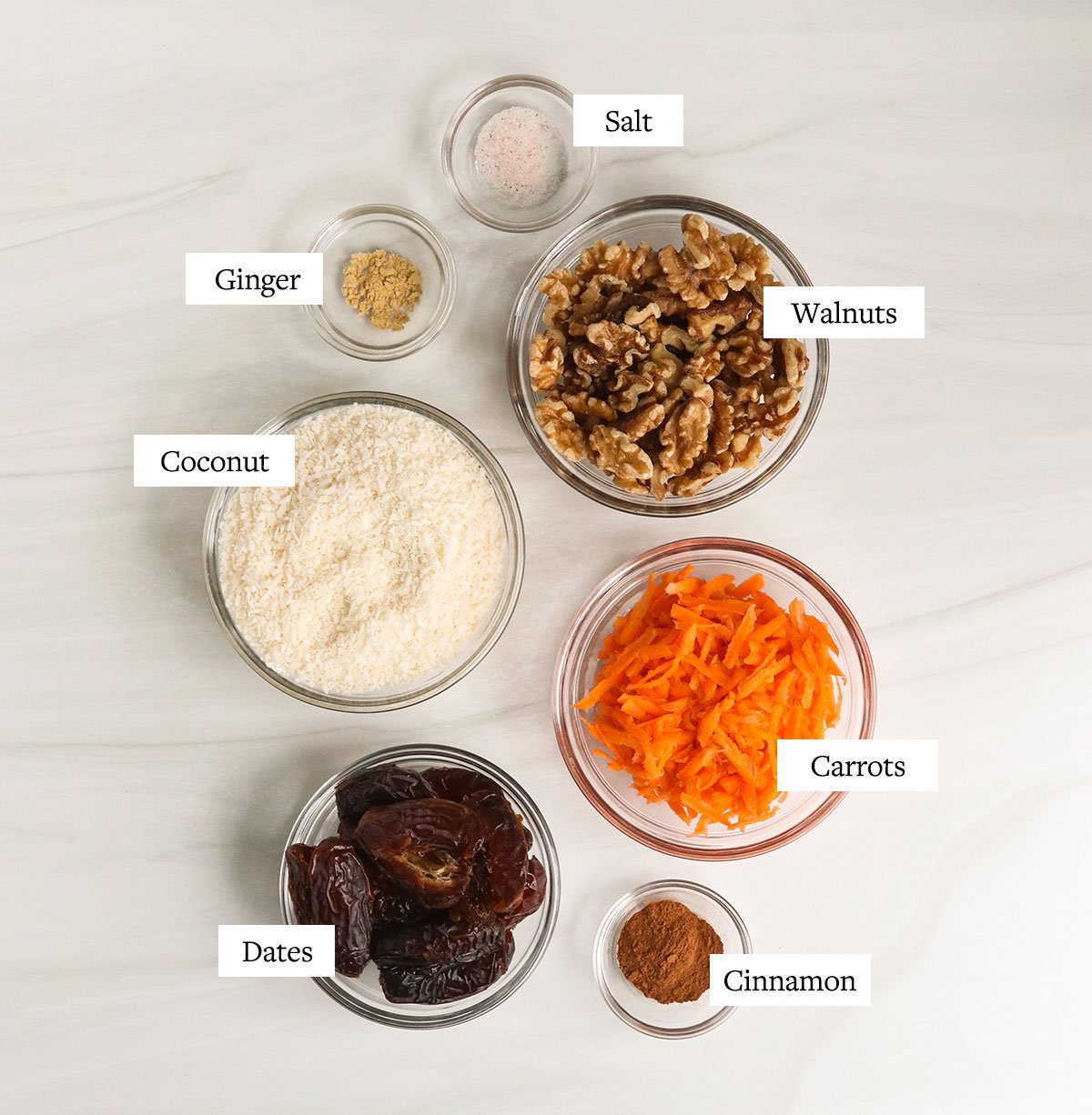 carrot cake bite ingredients labeled in glass bowls.