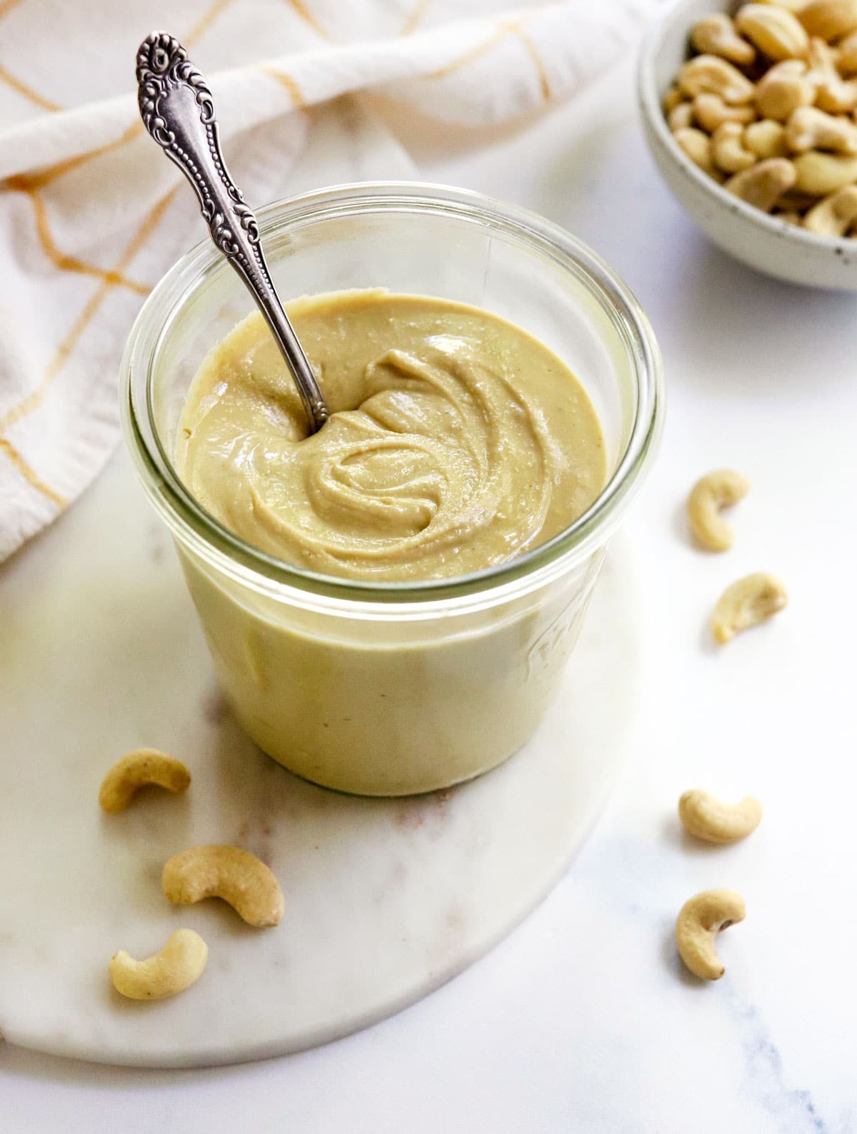 jar of cashew butter with a spoon inside