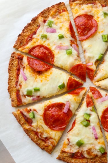 Finished cauliflower pizza cut into slices.