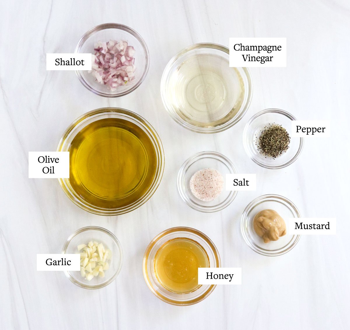 champagne vinaigrette dressing ingredients in glass bowls.