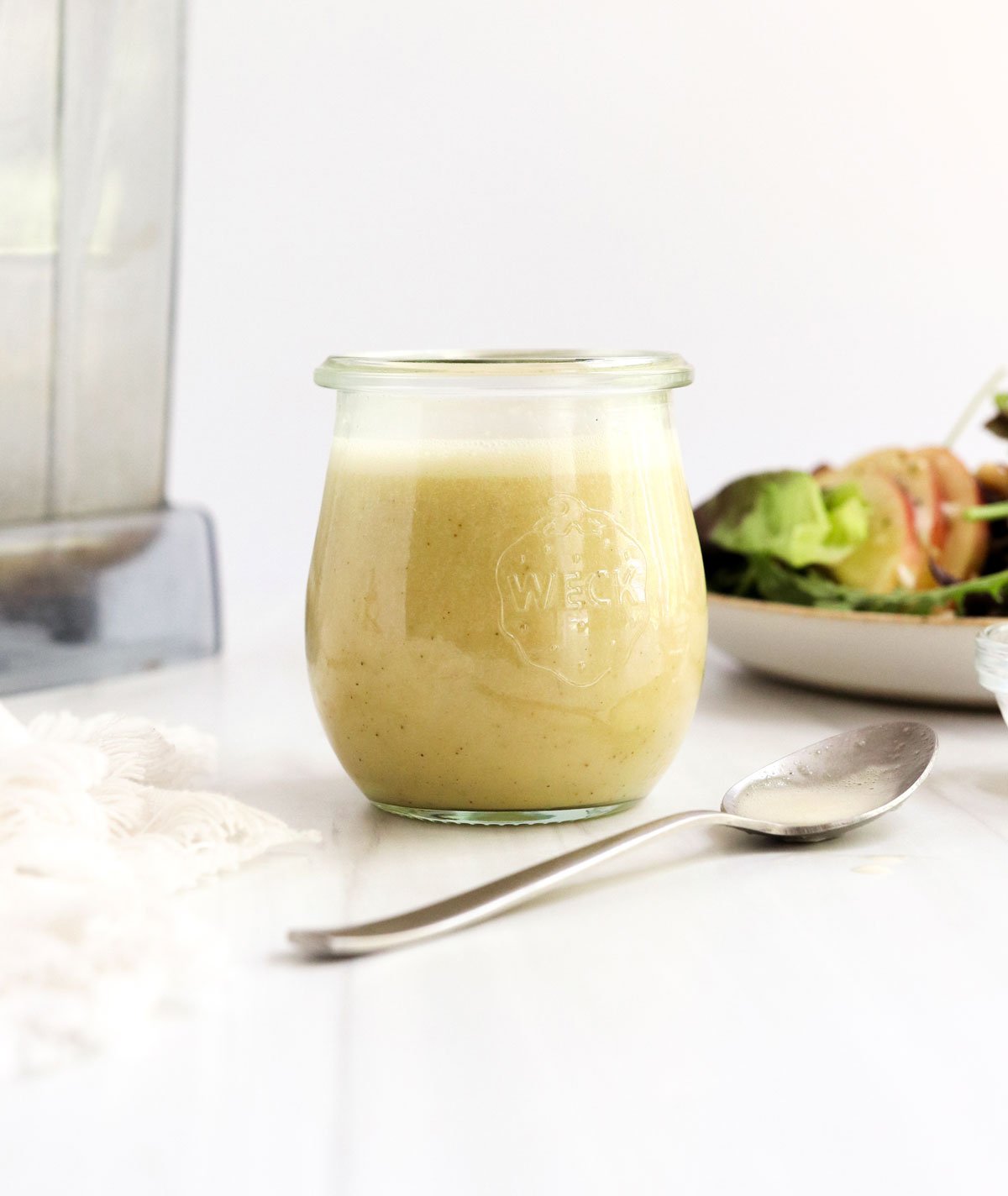 champagne dressing in glass jar with spoon.