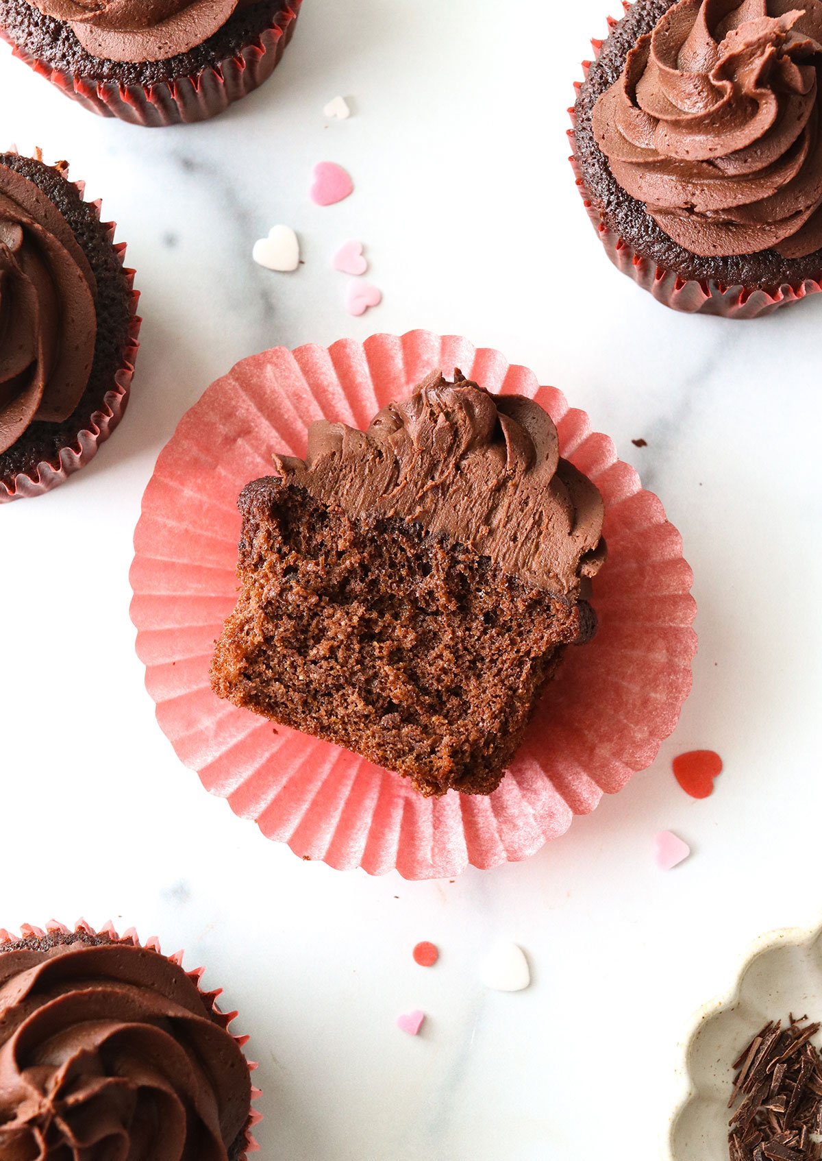 chocolate almond flour cupcake cut in half on a wrapper.