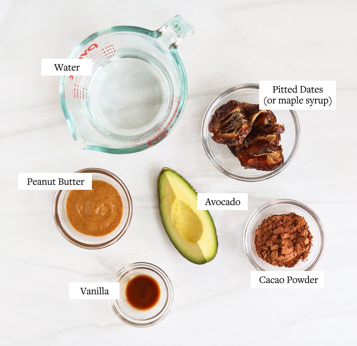 avocado smoothie ingredients labeled in glass bowls.