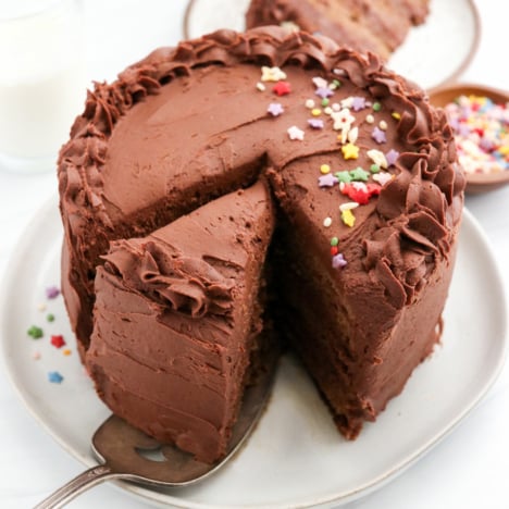 healthy birthday cake sliced with chocolate frosting on top.