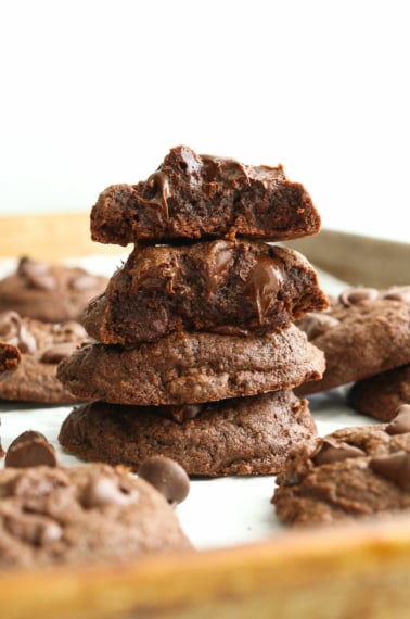 chocolate buckwheat cookies stacked and in half to show the texture.