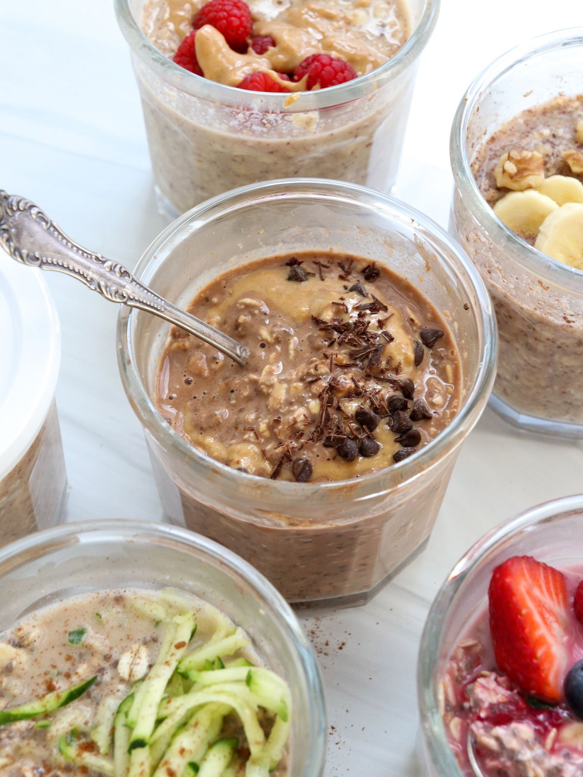 chocolate shavings on top of chocolate oats in glass jar with spoon