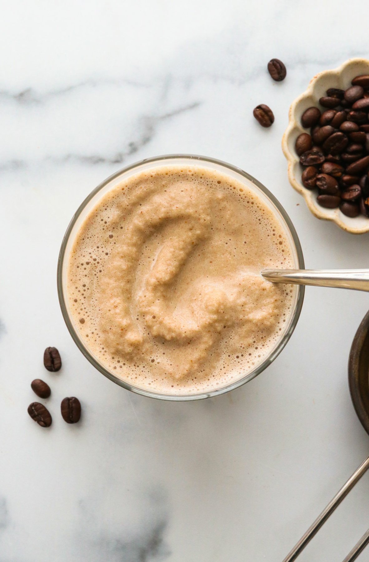 Slushy coffee smoothie overhead in a glass.