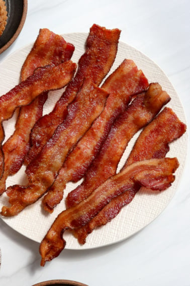 air fryer bacon on a white plate.