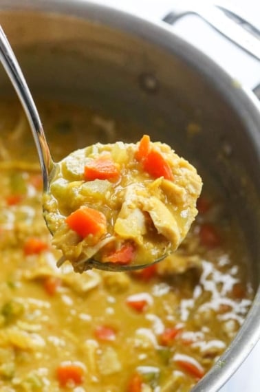 curry chicken soup in ladle