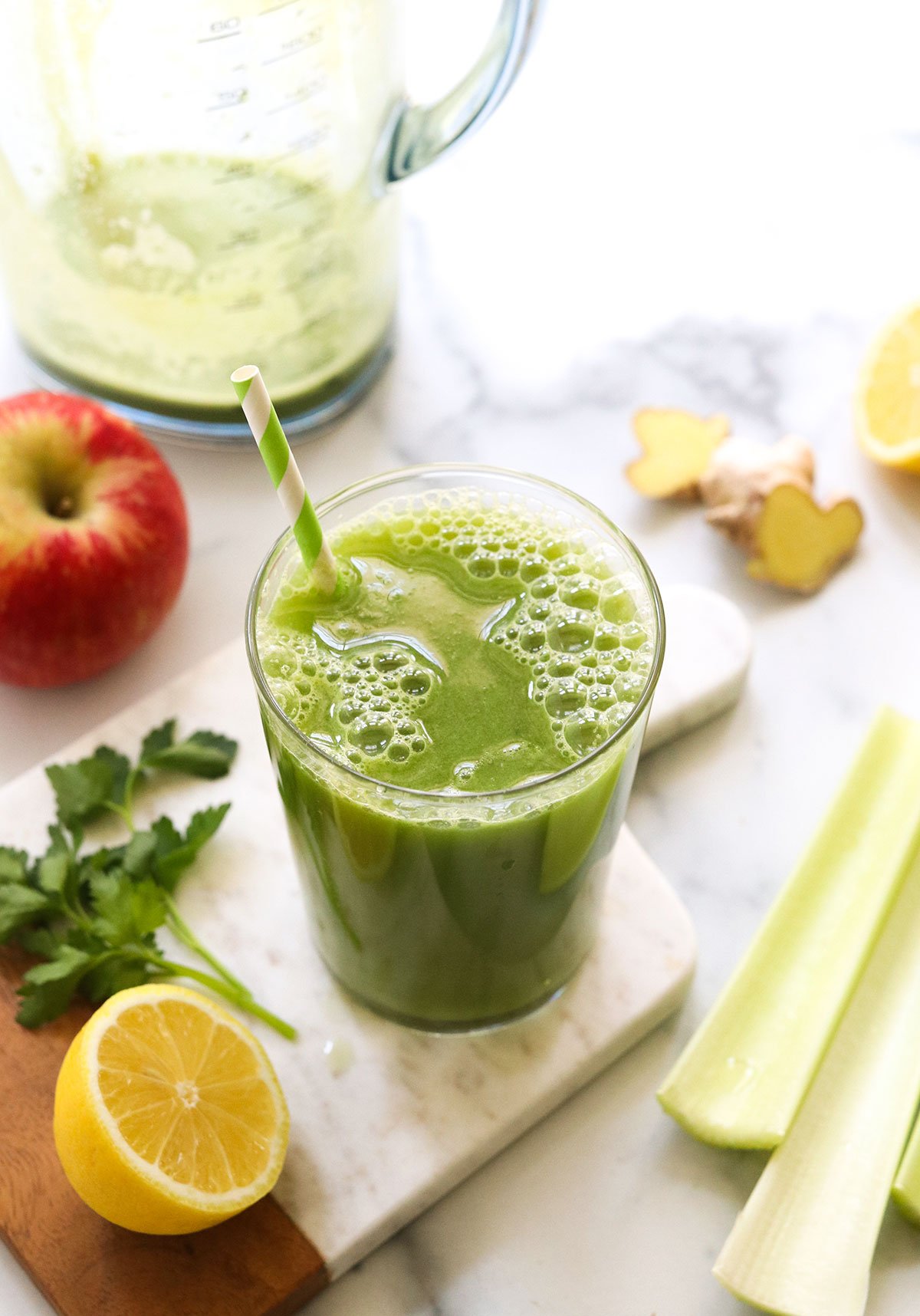 detox juice served on a marble board with fresh produce.