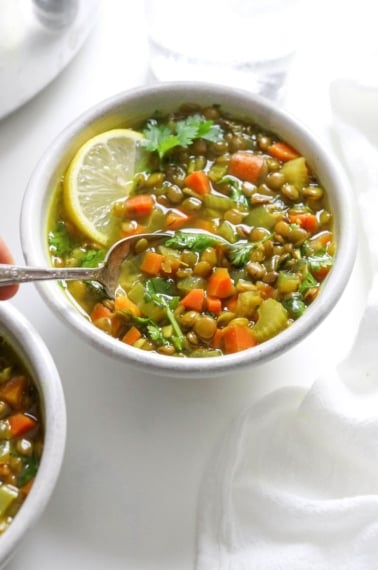 spoon dipped into bowl of soup