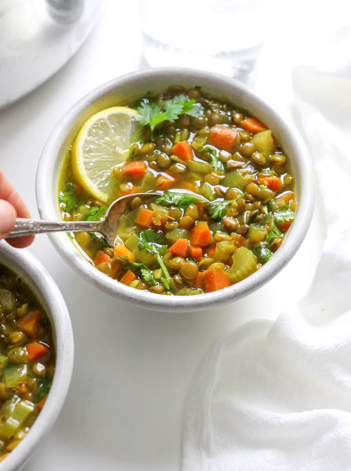 spoon dipped into bowl of soup