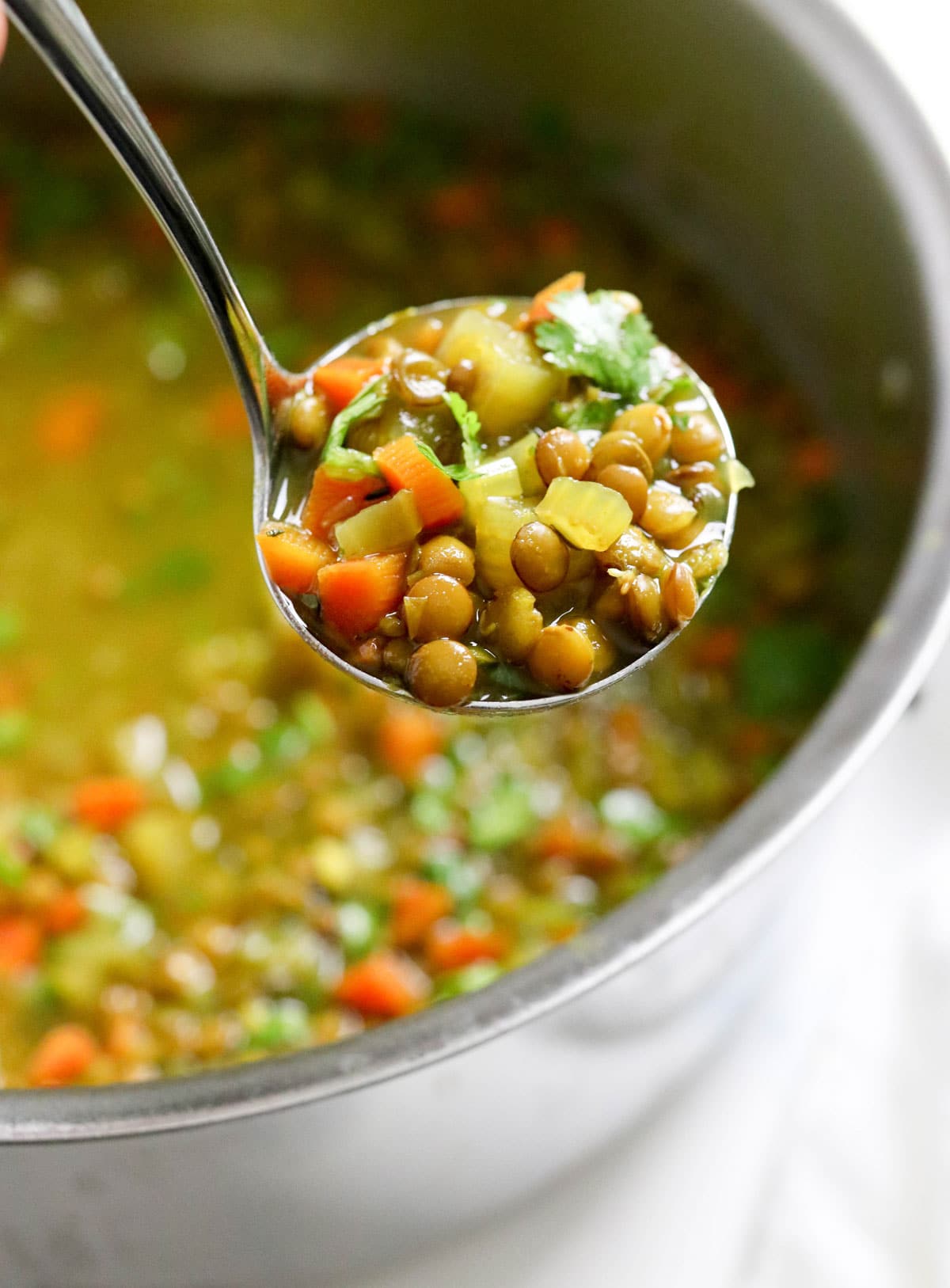 detox soup scooped up into ladle