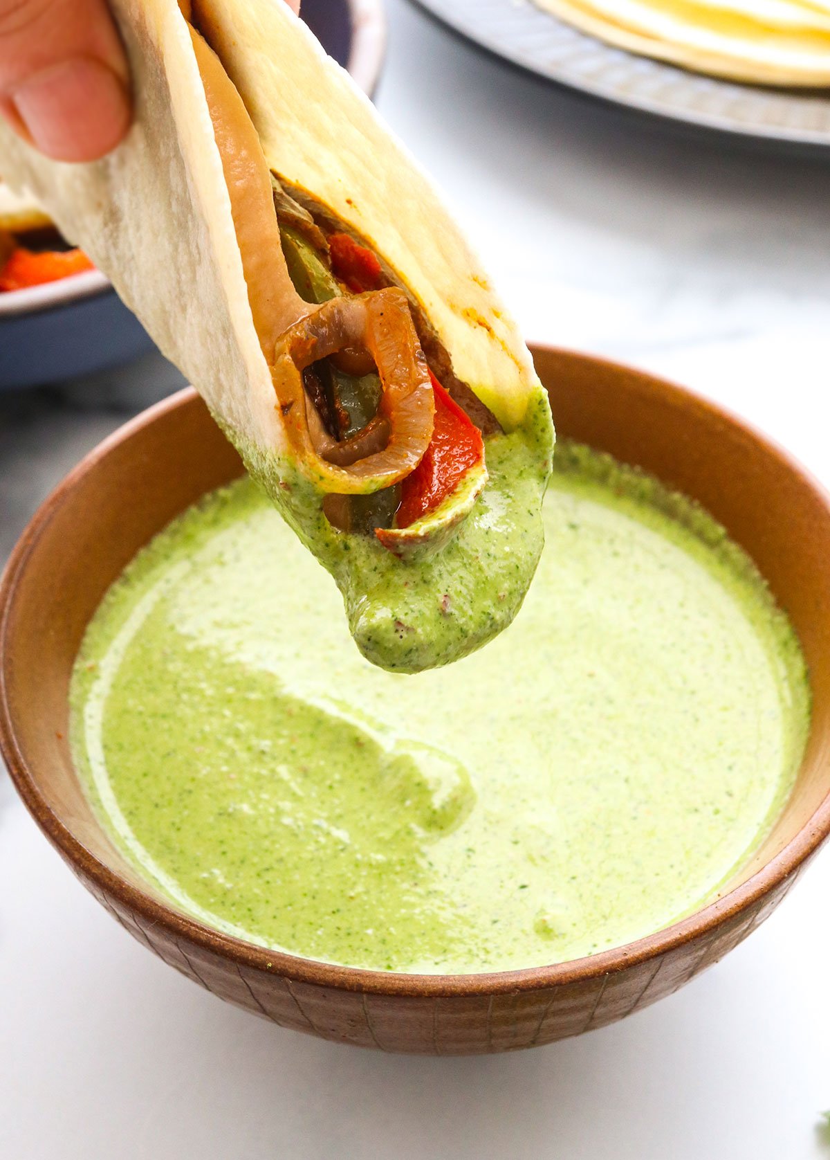 Vegan Fajita dipped in creamy cilantro sauce.