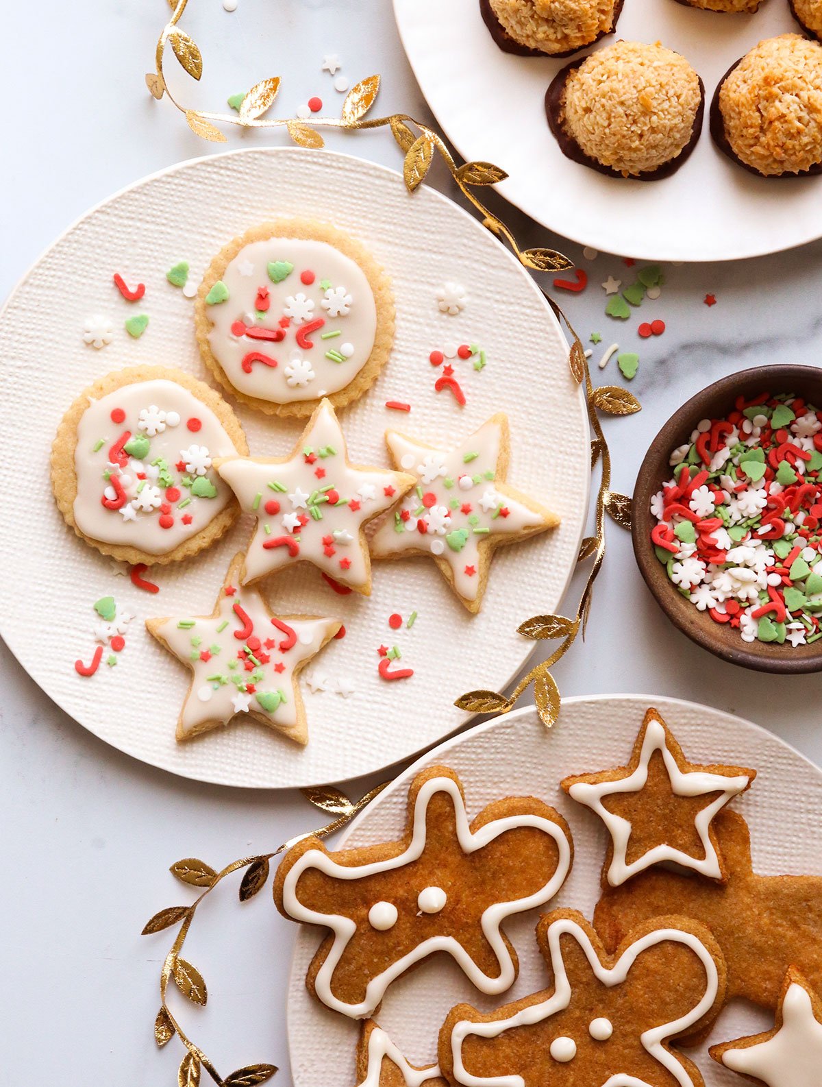 gluten free sugar cookies and gingerbread cookies on plates.