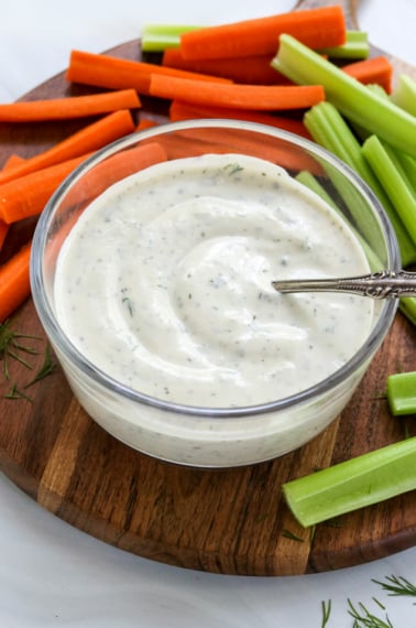 greek yogurt dressing served with sliced veggies.