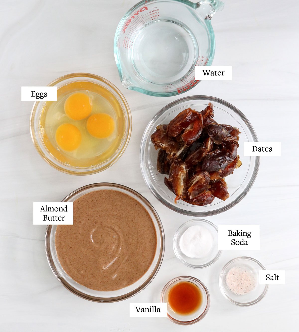 healthy birthday cake ingredients in glass bowls.