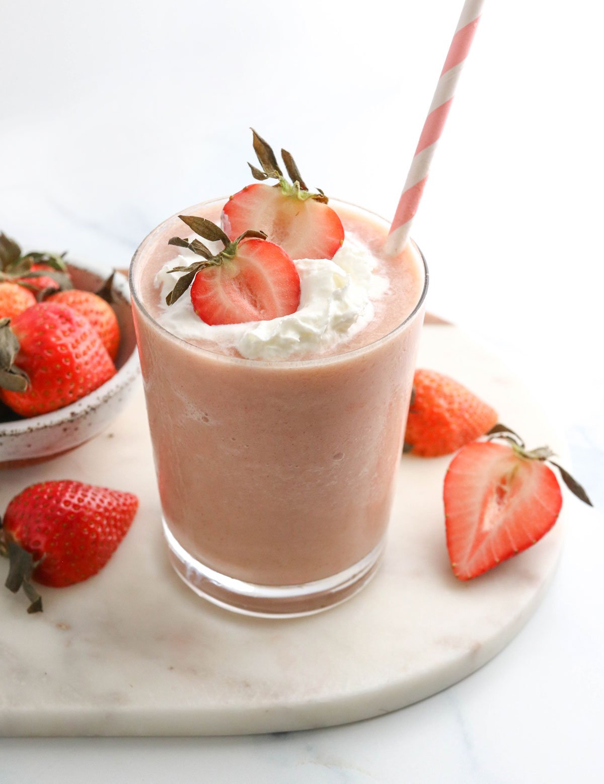 healthy strawberry milkshake with whipped cream on top