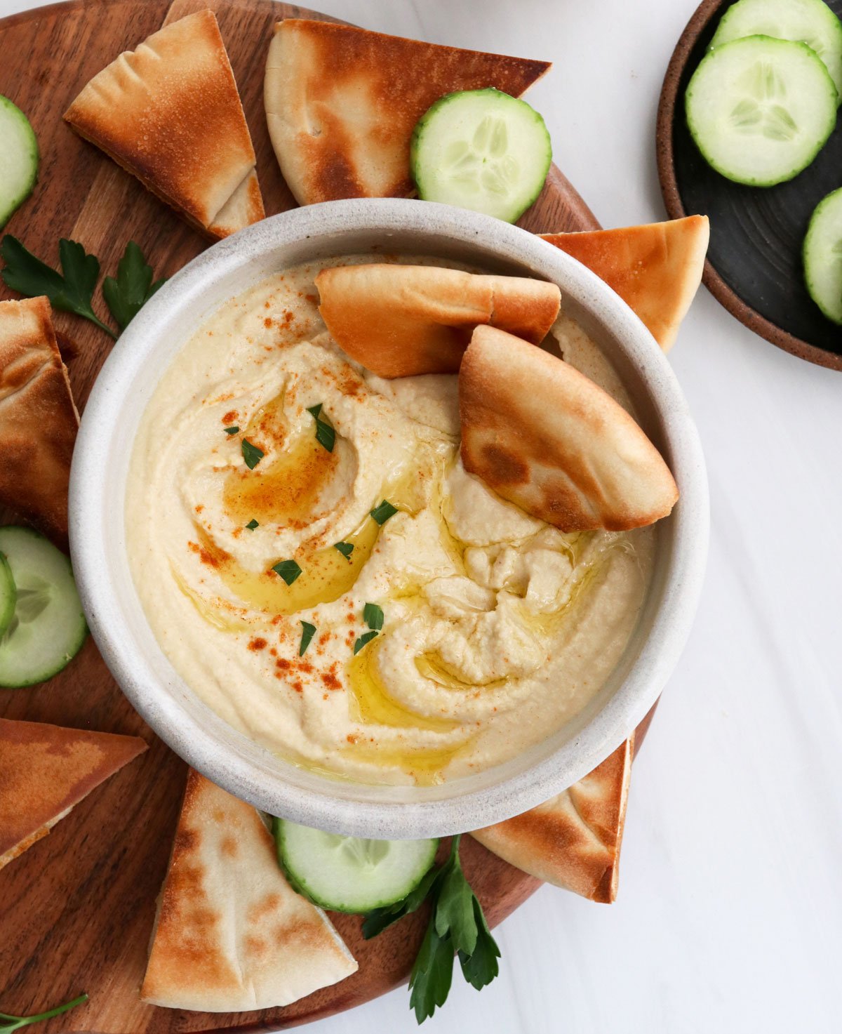 hummus served with toasted pita bread and olive oil on top.