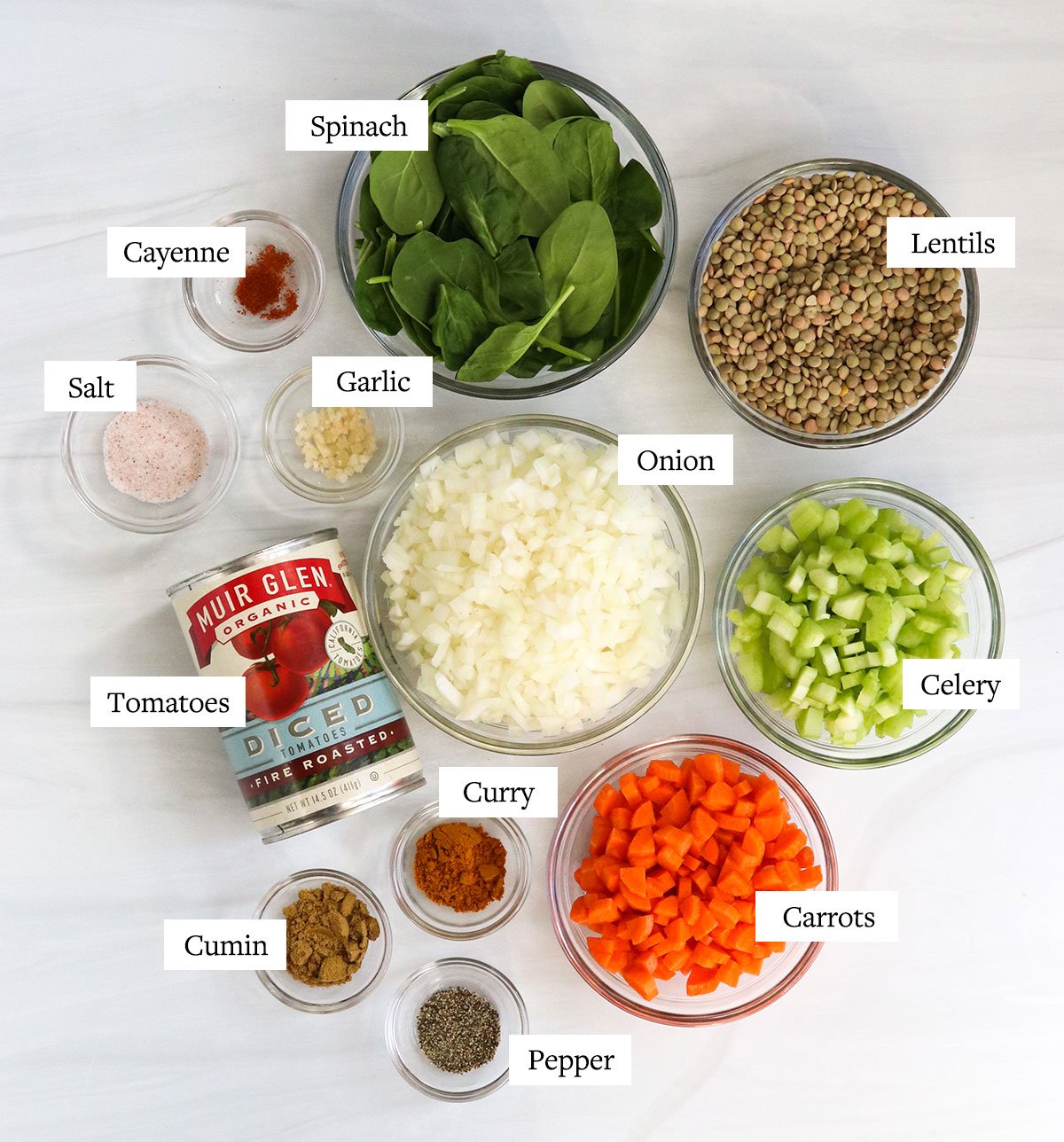 Instant pot lentil soup ingredients labeled in glass bowls.