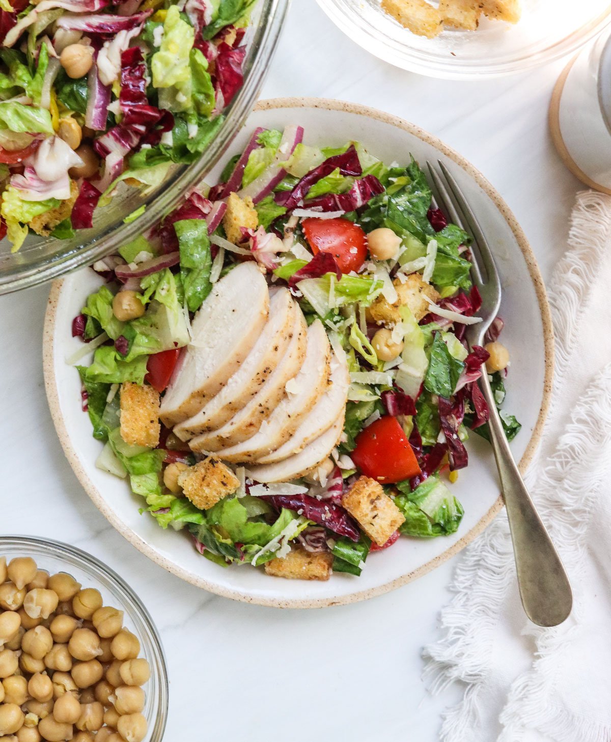 italian salad topped with sliced chicken.