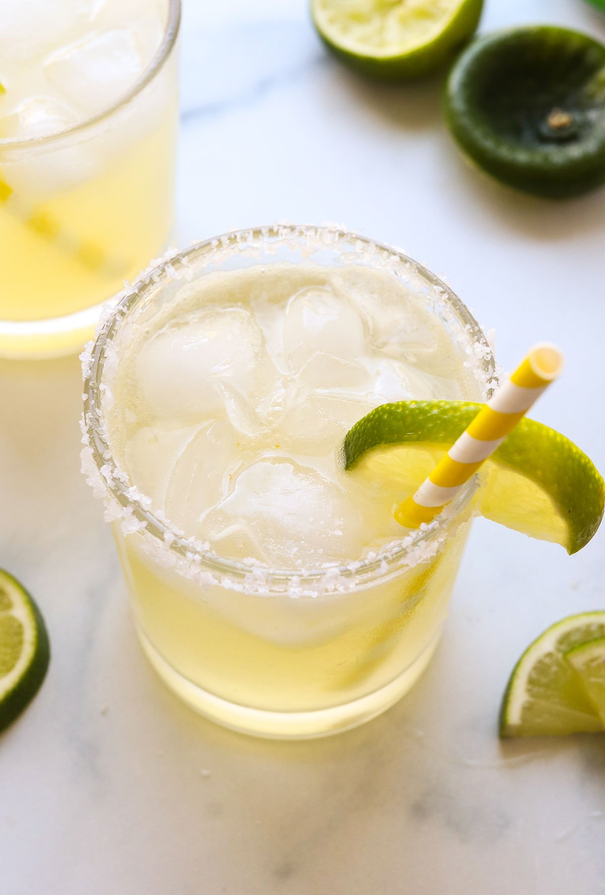 close up of a margarita mocktail with a yellow striped straw.