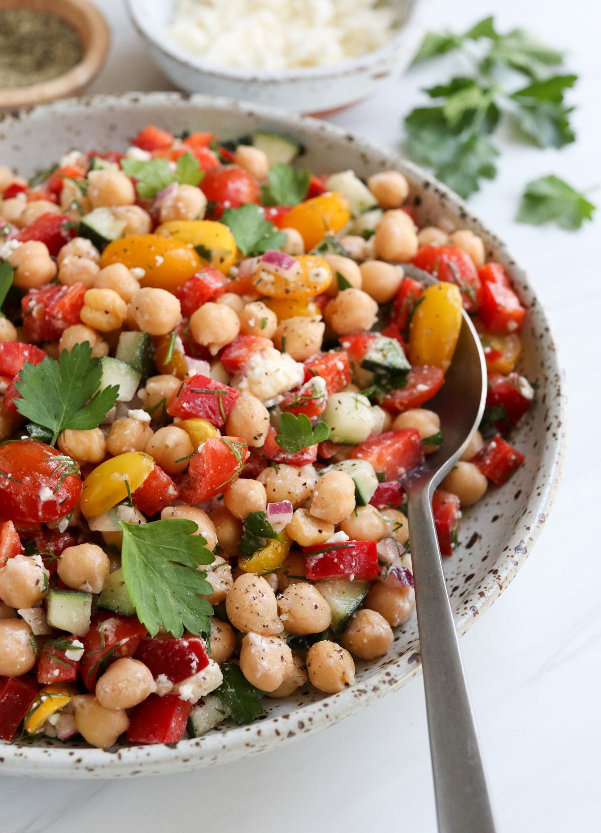 mediterranean chickpea salad with a serving spoon.