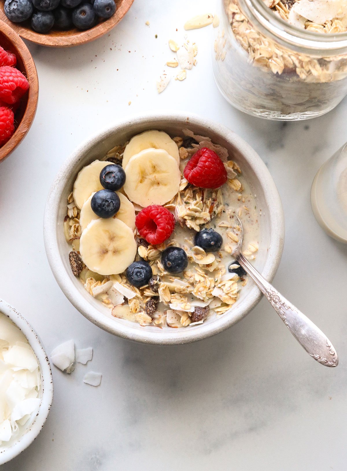 muesli served with milk and a spoon.