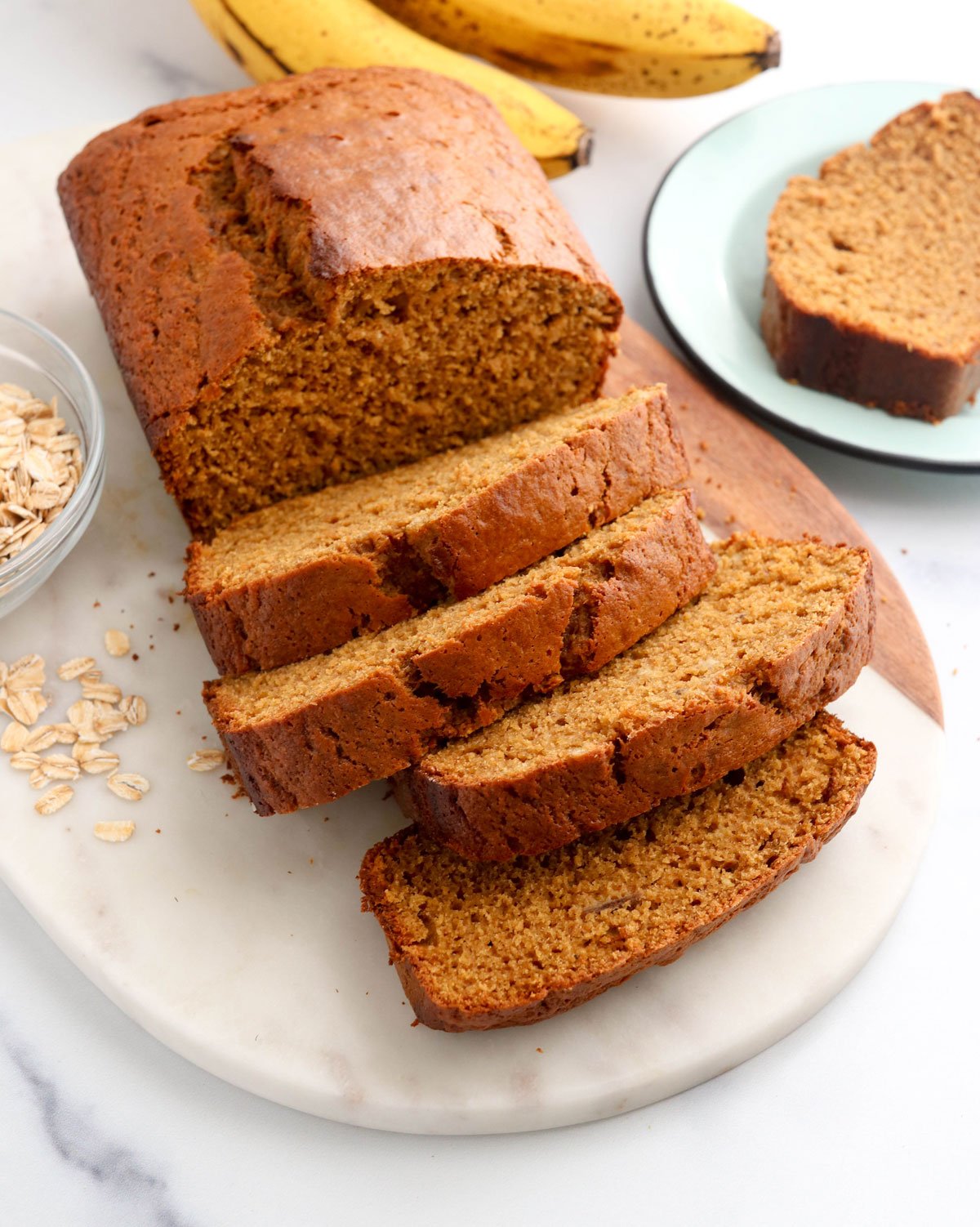 oat flour banana bread sliced on marble board