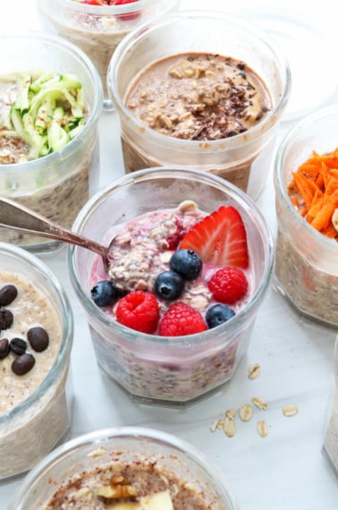 overnight oats with different toppings and flavors in glass jars