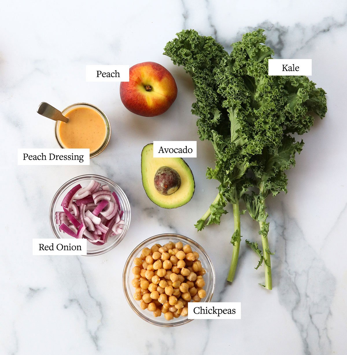 peach salad ingredients labeled on marble surface.