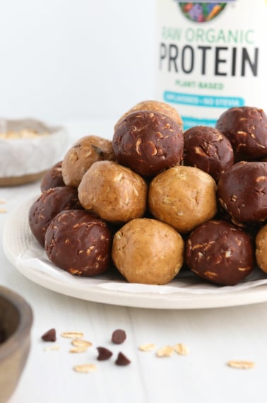 protein balls in 3 flavors stacked on white plate.