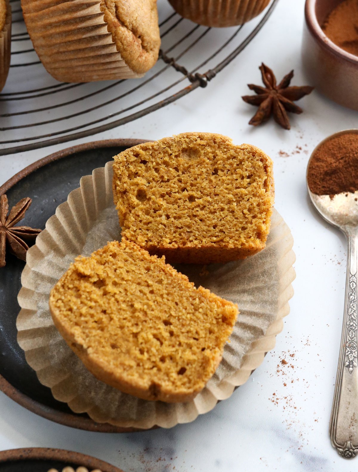 vegan pumpkin muffin cut in half on plate