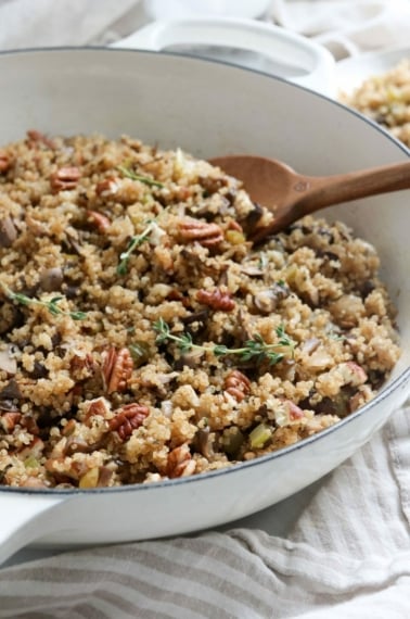 quinoa pilaf with pecans and fresh thyme in pan