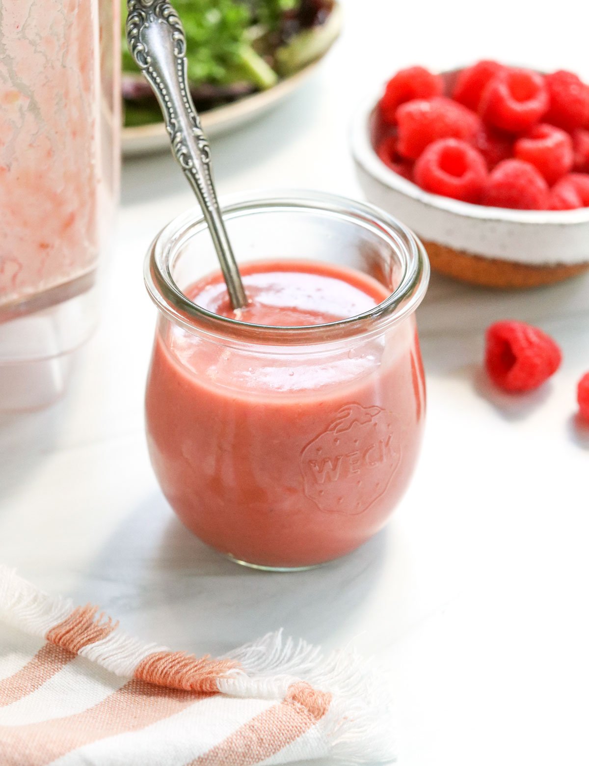 raspberry vinaigrette in glass jar with spoon.