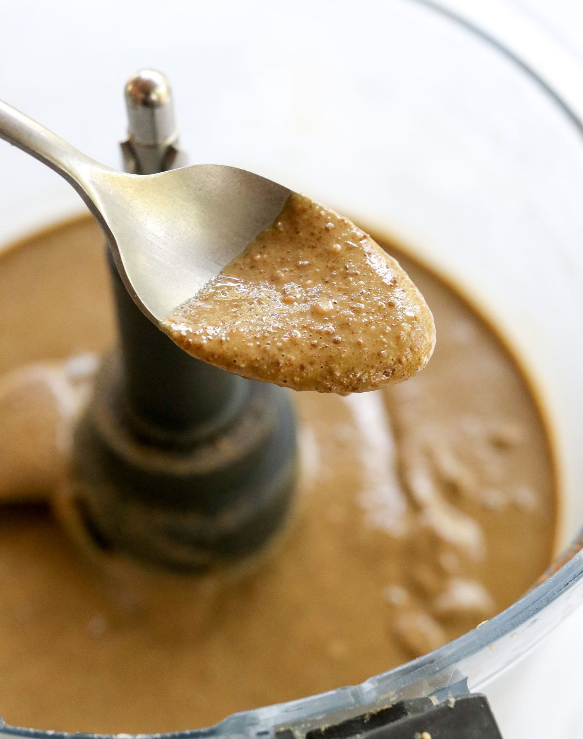 sunflower seed butter lifted up on a spoon.