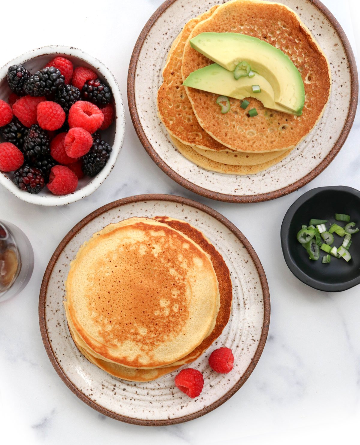 chickpea pancakes topped with avocado and berries